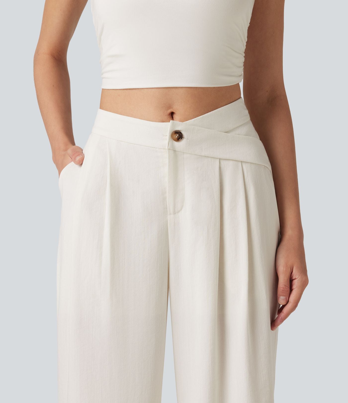 Pantalon large fluide asymétrique taille mi-haute plissé avec poches et aspect lin