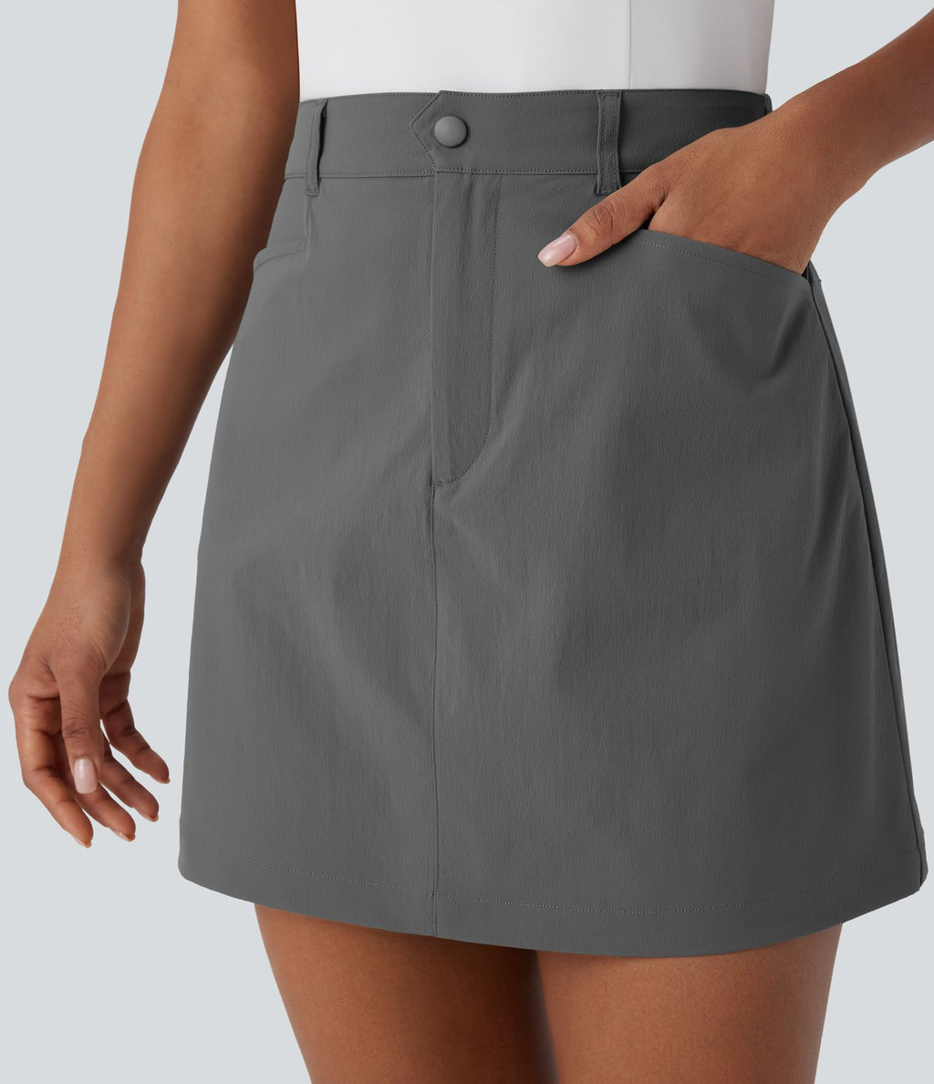 Jupe courte de golf ligne A taille haute avec boutons, zip, poches latérales et fente