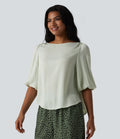Blouse décontractée à manches bouffantes et ourlet arrondi texturé
