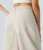 Pantalon décontracté à taille mi-haute, coupe ample et jambes fuselées, avec poches