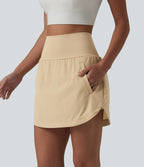 Jupe de golf 2-en-1 taille ultra haute ventre plat avec ourlet arrondi et poches