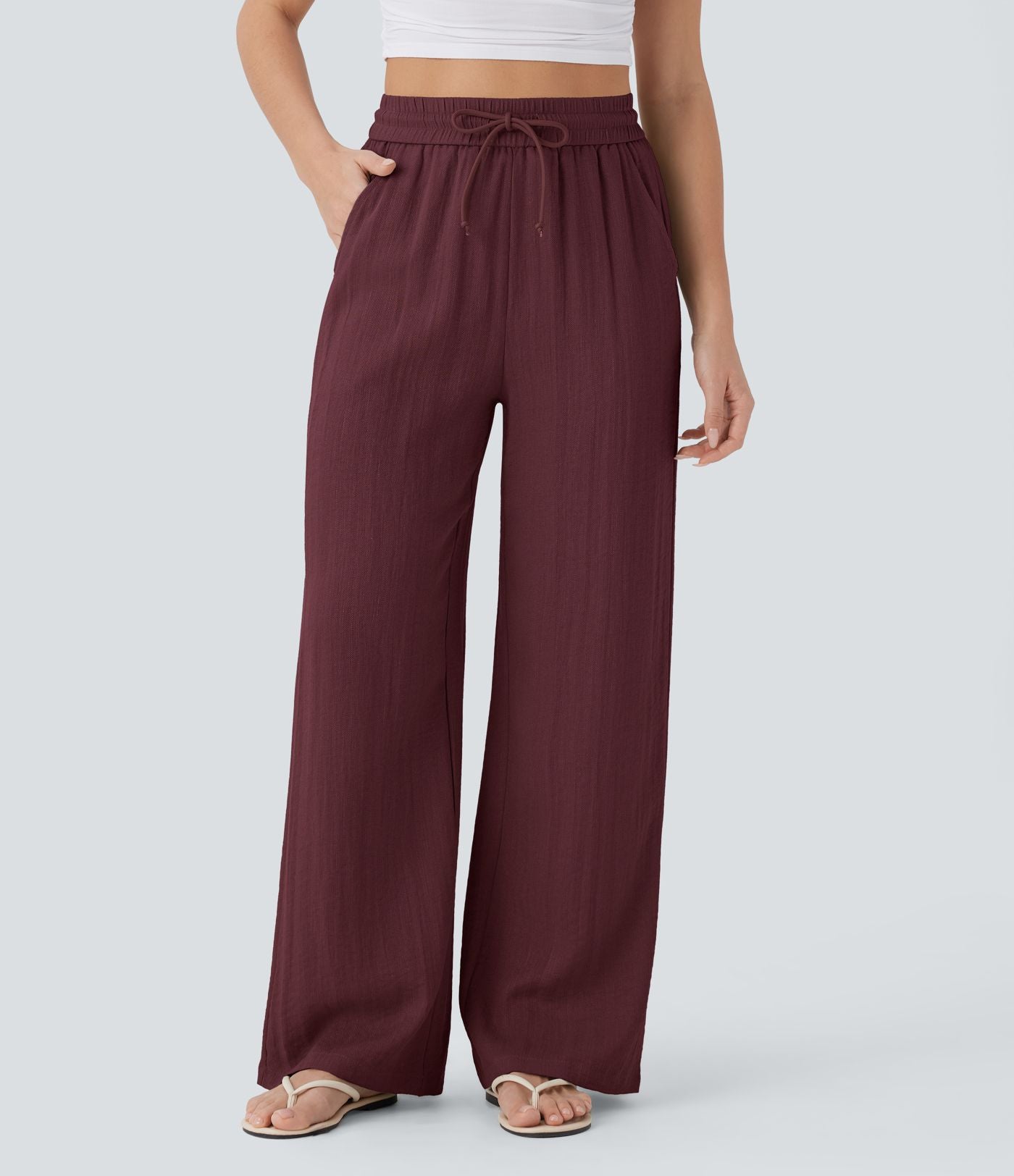 Pantalon large fluide taille haute avec cordon de serrage, poches latérales et aspect lin