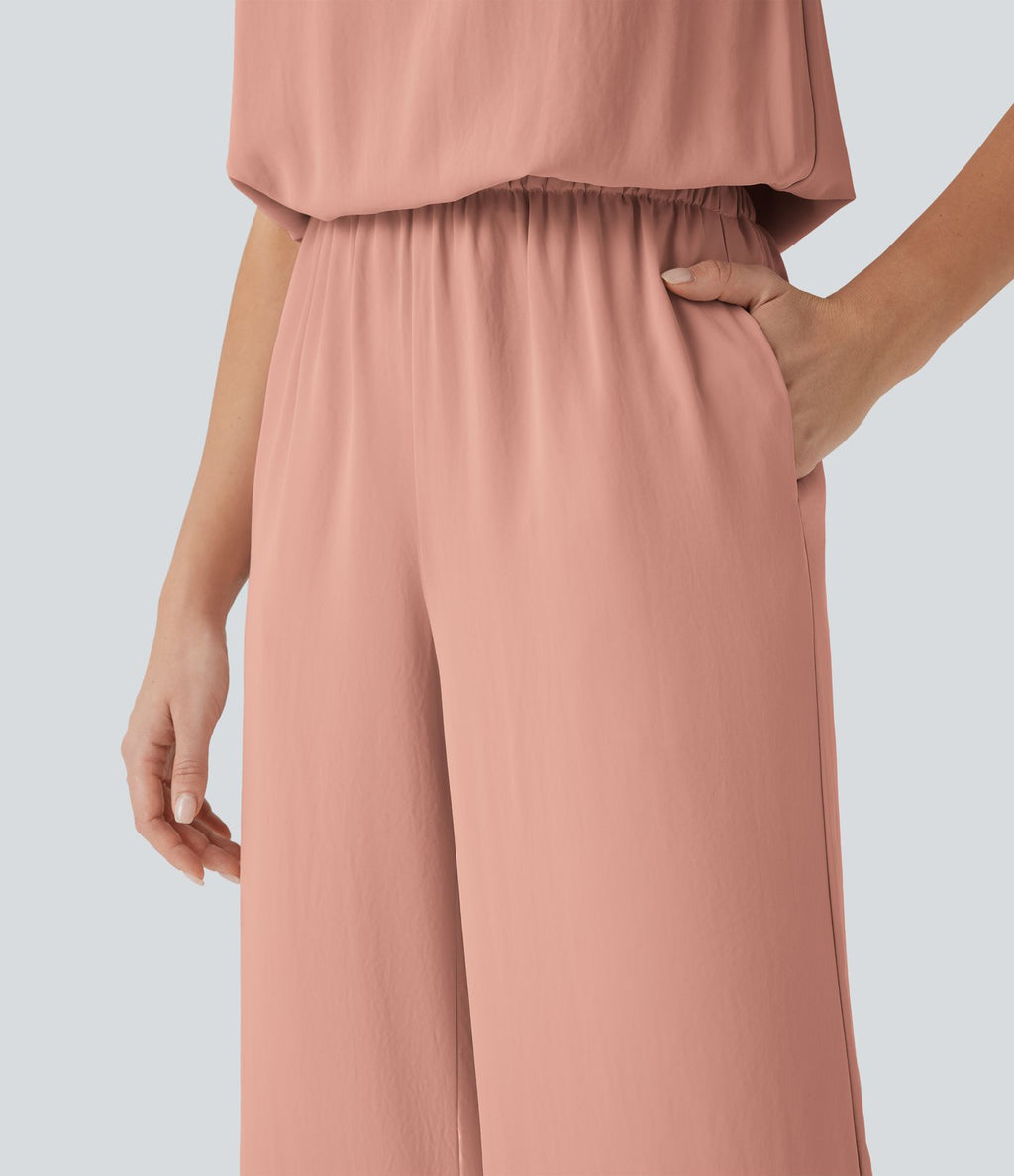 Combinaison pantalon tailleur jambes larges col montant dos goutte d'eau manches courtes avec poches latérales