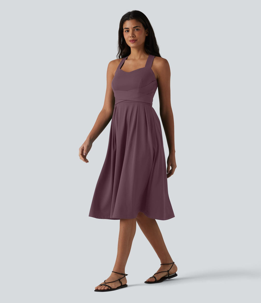 Robe midi fluide sans manches décolleté cœur avec bretelles croisées, nœud dans le dos et poches