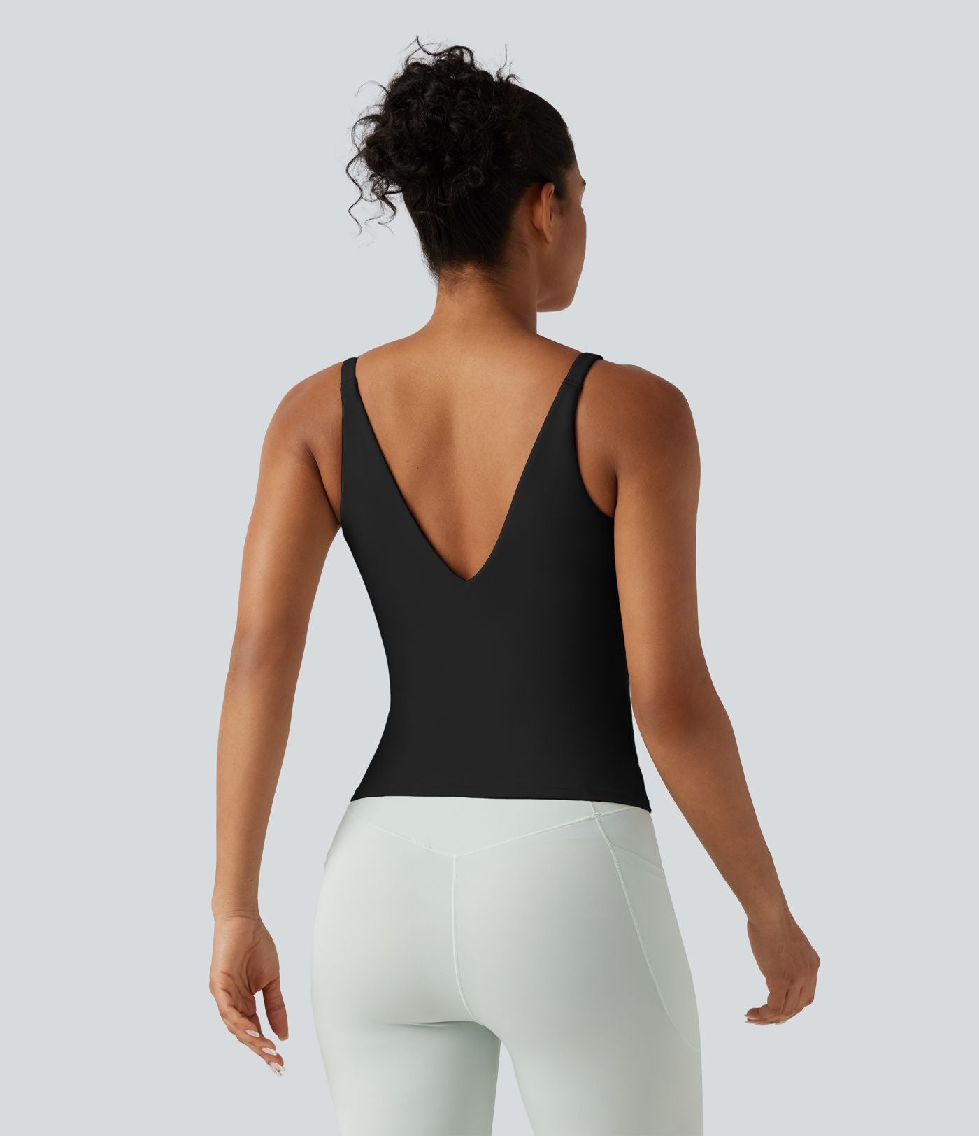Débardeur de sport effet lissant sous les bras avec dos en V et brassière intégrée