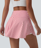 Jupe de tennis mini 2 en 1 à rayures, taille haute croisée, ourlet arrondi et poches
