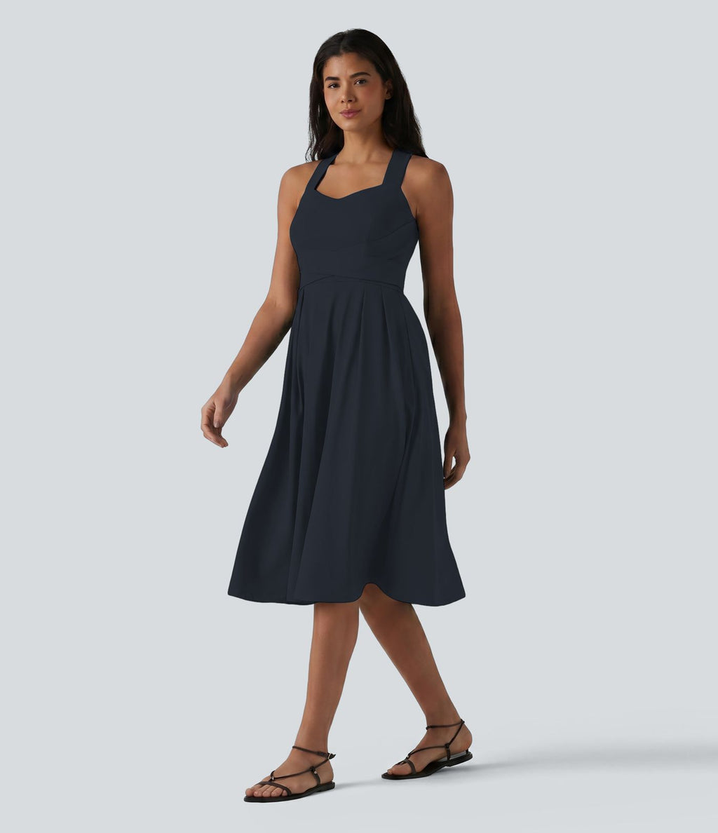 Robe midi fluide sans manches décolleté cœur avec bretelles croisées, nœud dans le dos et poches