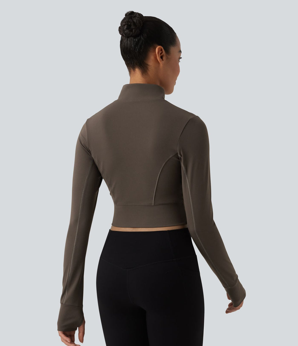 Haut de sport court col cheminée demi-zip manches longues avec passe-pouces
