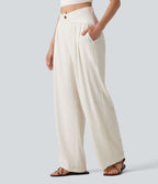 Pantalon large fluide asymétrique taille mi-haute plissé avec poches et aspect lin