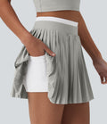 Jupe mini de tennis plissée 2-en-1 Breezeful™ color block taille haute à séchage rapide avec poches