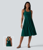 Robe midi fluide sans manches décolleté cœur avec bretelles croisées, nœud dans le dos et poches
